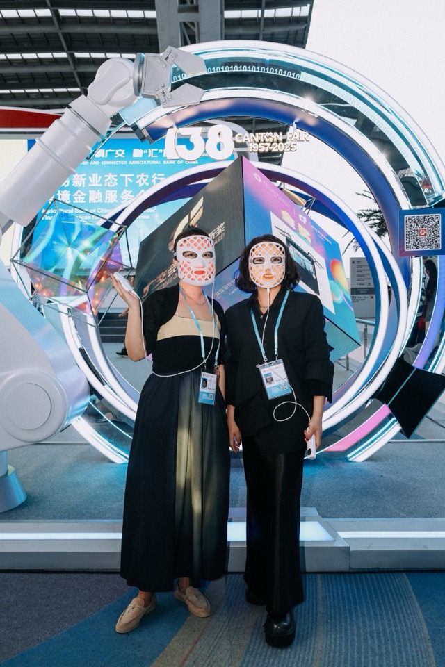 Global buyers at Radiant booth wearing LED face masks